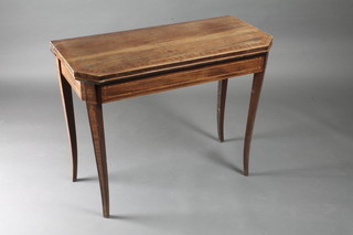 A Georgian mahogany lozenge shaped card table with  crossbanded top, raised on square tapering supports 35"w x 17   1/2"d x 28" 1/2"h