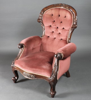 A Victorian mahogany show frame armchair upholstered in pink buttoned material raised on cabriole supports
