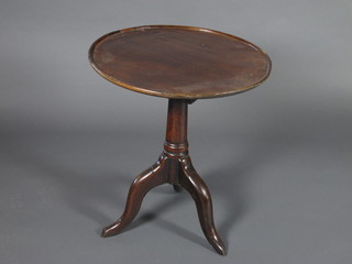 A circular Georgian mahogany dish top wine table with bird cage action, raised on a pillar and tripod base 22"w x 25"h
