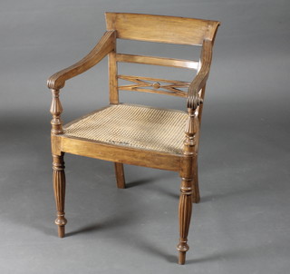 An Anglo Indian mahogany bar back desk chair with woven cane  seat, raised on turned and reeded supports