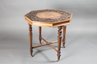A Victorian octagonal carved walnut occasional table raised on  square tapering supports with X framed stretcher 27"w x 25  1/2"h
