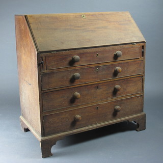 A Georgian mahogany bureau, the fall front revealing a well  fitted interior above 4 long graduated drawers with tore handles,  raised on bracket feet 39"w x 20 1/2"d x 42"h
