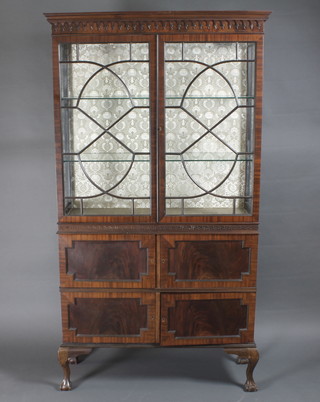 An Edwardian Georgian style mahogany display cabinet with  moulded cornice, the upper section fitted shelves enclosed by  astragal glazed doors, the base fitted 2 cupboards enclosed by  panelled doors 41"w x 14" 1/2"d x 75"h