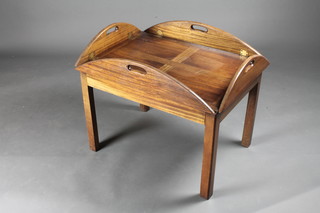 A folding mahogany butler's tray table, raised on square tapering  supports 29 1/2"w x 22"d x 23 1/2"h