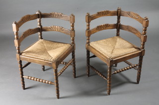 A pair of carved beech corner chairs with bobbin turned supports