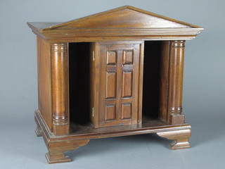 A Georgian style mahogany Portico shaped cabinet with panelled door to the centre with secret drawers, raised on bracket feet  17"w x 11 1/2"d x 16"h