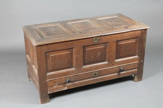 An 18th Century oak coffer of panelled construction the base fitted a drawer 44"w x 21"d x 23 1/2"h