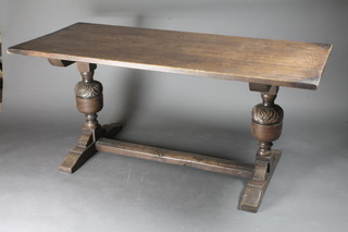 An oak refectory style dining table raised on bulbous turned  supports with H framed stretcher 56"w x 30"d x 29"h