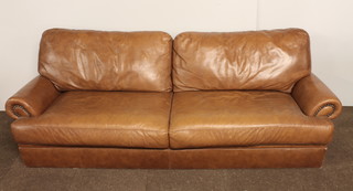 A 2 seat settee upholstered in brown hide 92"w x 36"d x 30"h