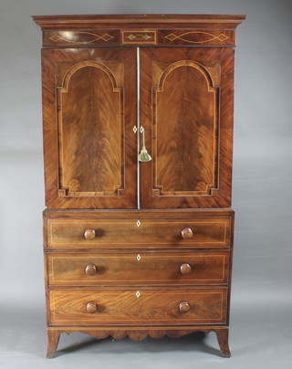 A handsome 19th Century inlaid mahogany linen press with  moulded cornice, the upper section fitted 1 tray and 2 shelves  enclosed by arched panelled doors, the base fitted 3 long drawers  with ivory escutcheons and tore handles, raised on splayed  bracket feet 47"w x 23"d x 81"  ILLUSTRATED  FRONT COVER