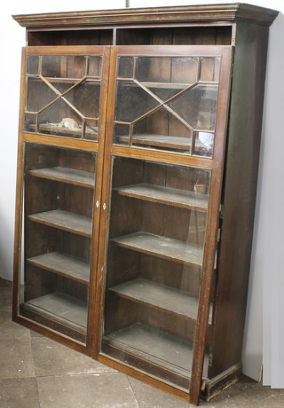 A 19th Century pine and mahogany bookcase with moulded  cornice fitted shelves enclosed by astragal glazed panelled doors,  raised on a platform base 63"w x 15"d x 78"h
