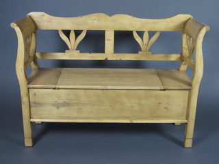 A Continental stripped pine settle with hinged lid 50"w x 16"d x  36"h