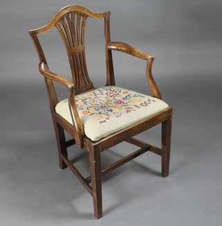 A Georgian mahogany Hepplewhite camel back carver chair with upholstered drop in seat, raised on square tapering supports