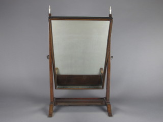 A 19th Century rectangular plate dressing table mirror contained  in a mahogany swing frame and with turned ivory finials 14" x  23"