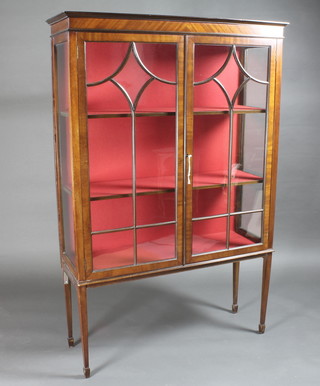 An Edwardian mahogany display cabinet with moulded cornice,  the interior fitted shelves enclosed by astragal glazed panelled  doors 42"w x 14"d x 64"h