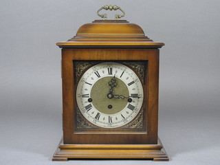 A chiming bracket clock with 6" silvered dial with Roman  numerals contained in a walnut case