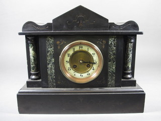 A Victorian French 8 day striking mantel clock with enamelled  dial and Arabic numerals contained in a black marble  architectural case