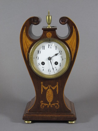 A 19th Century French 8 day striking mantel clock with  enamelled dial and Arabic numerals contained in a shaped inlaid  mahogany case  ILLUSTRATED