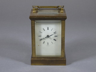 A French 8 day carriage clock with enamelled dial and Roman  numerals contained in a gilt metal case