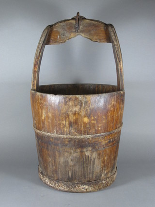 A circular wooden well bucket