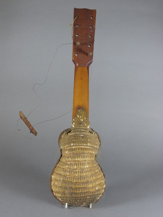A 10 stringed musical instrument, the back formed from an Armadillo