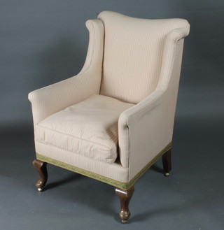A Georgian style winged armchair upholstered in striped material