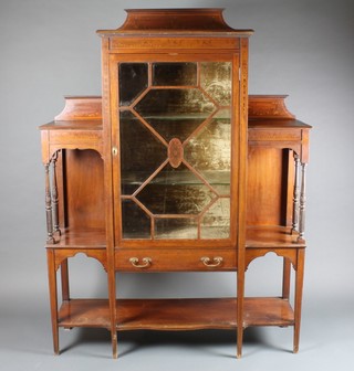 An Edwardian inlaid mahogany display cabinet, the centre section fitted shelves enclosed by bevelled plate astragal glazed  doors with drawer beneath flanked by a pair of niches, raised on  square tapering supports by Maple & Co 48"w x 13"d x 65"h