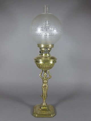 A reeded brass oil lamp reservoir supported by a figure of a  classical lady complete with clear glass shade and chimney 27"