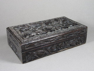 A heavily carved Eastern trinket box with hinged lid 11" x 6" x  3"