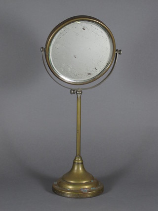 A circular brass cased adjustable mirror