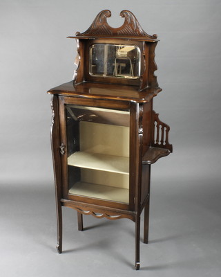 An Edwardian walnut music/display cabinet with raised mirrored back, the interior fitted shelves with niches to the sides, raised on  cabriole supports 23"w x 13"d x 58"h