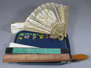 A double sided razor strop, a lacquered tray and a fan