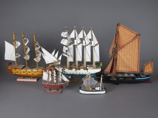 A wooden model of Thames barge and 4 models of boats