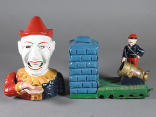 A reproduction money box in the form of an artillery man 7" and  1 other in the form of a clown 6"