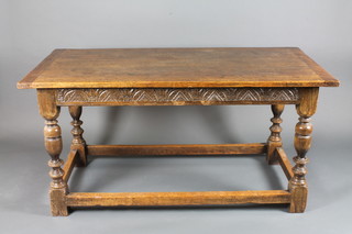 A carved oak refectory style dining table with planked top,  carved frieze raised on bulbous turned supports with box work  stretcher 60"w x 30"d x 29 1/2"h