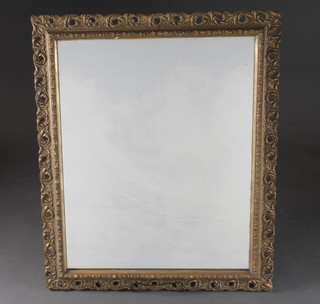 A plate wall mirror contained in a decorative gilt frame 25" x  30"