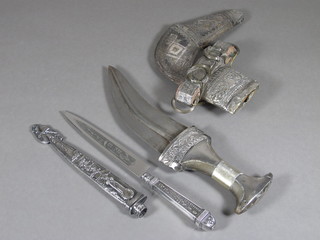 A Jambuka with 6" blade contained in a white metal scabbard  together with a Continental dagger with 5" blade and scabbard