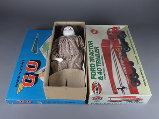 A porcelain doll, an Airfix Ford tractor and 40' trailer and a Waddingtons Go Game