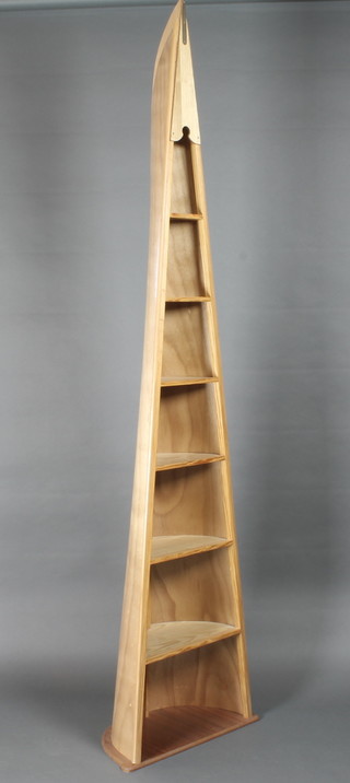 An oak and plywood book/display case in the form of a rowing  scull 21"w x 11"d x 83"h