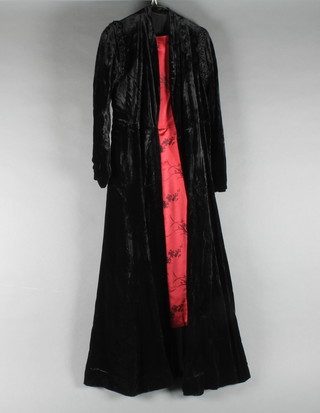 A 1950's red silk dress together with a black velvet coat