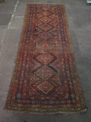 A Caucasian runner with 8 octagons to the centre within a  multi-row border 117" x 41"