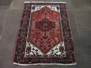 A contemporary red ground Eastern rug with octagon to the  centre 61" x 42"