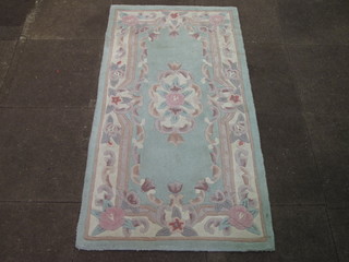 A green ground and floral patterned Chinese rug 60" x 31"