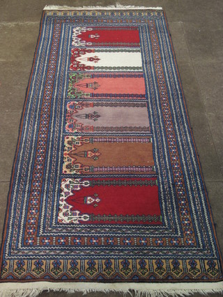 A rectangular Persian rug with 6 mihrab with mosque lamp to the centre 86" x 38"