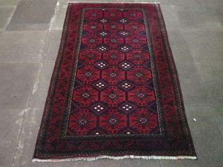 A red ground Afghan rug with all-over geometric design 78" x  45"