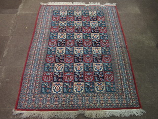 A Persian carpet formed of squares with floral design 70" x 50"