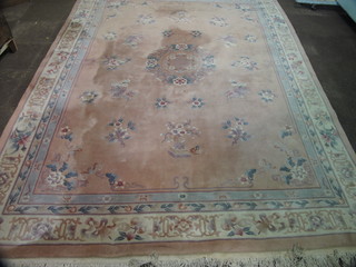 A peach coloured and floral patterned Chinese carpet 147" x  109"