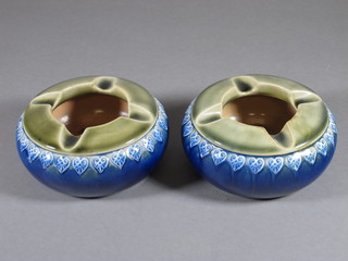 A pair of circular Doulton and green salt glazed ashtrays, the bases marked Royal Doulton N.Z.S Co X7623 4"