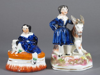 A Staffordshire pen rest in the form of a seated man with dog 4  1/2" f and r, and 1 other in the form of a standing boy with goat  5"