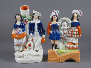 A Staffordshire flat back group of standing lady, gentleman and  Dog 7 1/2" and 1 other of standing Scotsman and lady with  parrot - r,